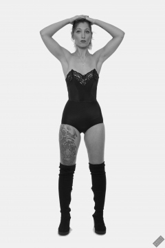 Michelle's Modelling in black strapless bra-top and matching black high-waist girdle, worn as hotpants, c/w tight leather corset-belt