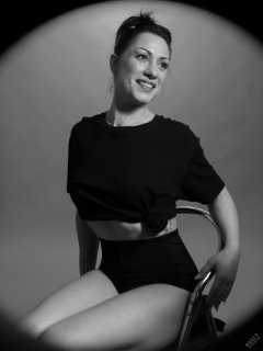 Athena Marie lit by RGB+CCT LED, in knotted T-shirt and vintage black control briefs worn as hotpants, studio shoot 2023-02-04