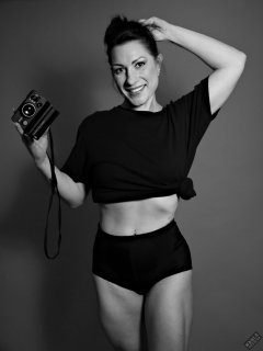 Athena Marie lit by RGB+CCT LED, in knotted T-shirt and vintage black control briefs worn as hotpants, studio shoot 2023-02-04