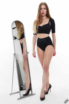 Kaya Lily in black posture top and black control briefs worn as hotpants