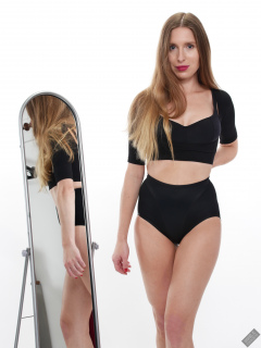 Kaya Lily in black posture top and black control briefs worn as hotpants