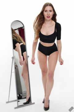 Kaya Lily in black posture top and black control briefs worn as hotpants