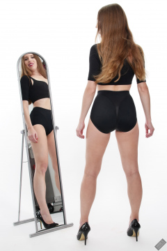 Kaya Lily in black posture top and black control briefs worn as hotpants