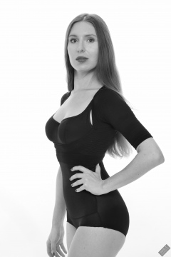 Kaya Lily in black posture top and black high-waisted control briefs worn as hotpants