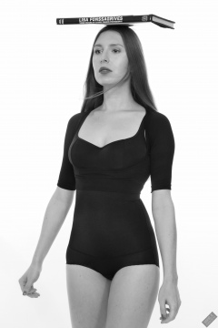 Kaya Lily in black posture top and black high-waisted control briefs worn as hotpants