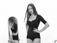 Kaya Lily in black posture top and black high-waisted control briefs worn as hotpants