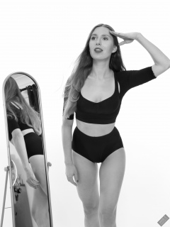 Kaya Lily in black posture top and black control briefs worn as hotpants