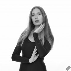 Kaya Lily in black long-sleeved lycra gymnastics leotard