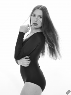 Kaya Lily in black long-sleeved lycra gymnastics leotard
