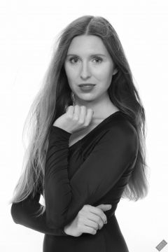 Kaya Lily in black long-sleeved lycra gymnastics leotard