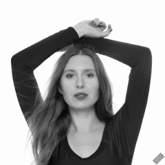 Kaya Lily in black long-sleeved lycra gymnastics leotard