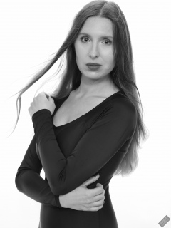Kaya Lily in black long-sleeved lycra gymnastics leotard