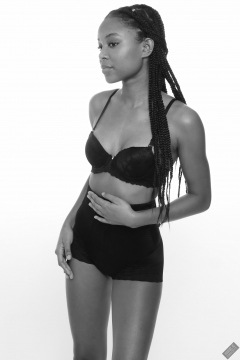 Caleann models black bra top and black waist-trainer control-briefs, worn as hotpants