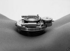 Caleann poses with vintage Bausch & Lomb shutter c/w Beck lens assembly on her tightly tucked-in tummy