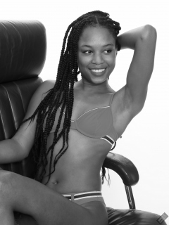 Caleann on leather chair, in  red sixties-style belted bikini