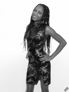 Caleann in tight black-and-gold Chinese cheongsam dress