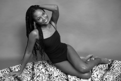 Caleann in tight black vintage-style tummy-control one-piece swimsuit by M&S