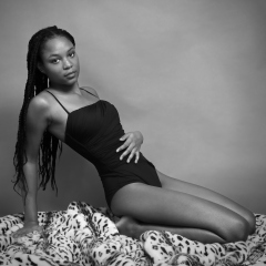 Caleann in tight black vintage-style tummy-control one-piece swimsuit by M&S