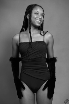 Caleann in tight black vintage-style tummy-control one-piece swimsuit by M&S