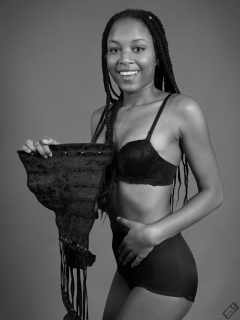 Caleann in black bra and girdle, anticipates donning the corset