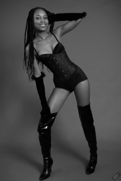 Caleann in tightly-laced black underbust corset, worn over black sixties-style bra and girdle