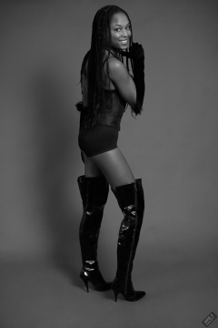 Caleann in tightly-laced black underbust corset, worn over black sixties-style bra and girdle