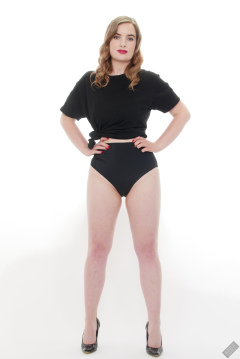 Harriet in black T-shirt, tied at the waist, with black control briefs worn as hotpants