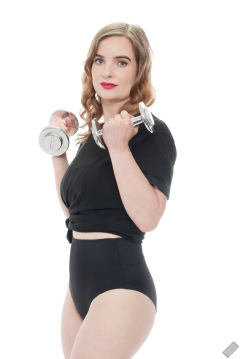 Harriet in black T-shirt, tied at the waist, with black control briefs worn as hotpants