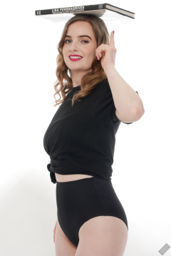 Harriet in black T-shirt, tied at the waist, with black control briefs worn as hotpants