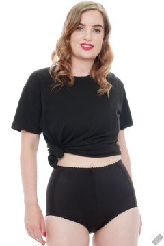 Harriet in black T-shirt, tied at the waist, with black control briefs worn as hotpants