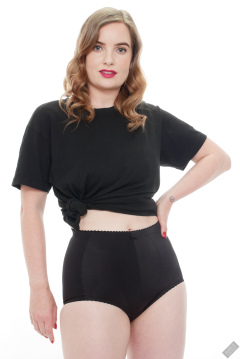 Harriet in black T-shirt, tied at the waist, with black control briefs worn as hotpants