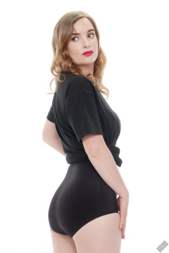Harriet in black T-shirt, tied at the waist, with black control briefs worn as hotpants