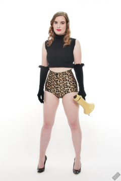 Harriet in black stretchy top and retro-style animal-print control-briefs worn as hotpants