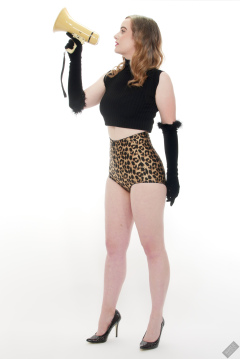 Harriet in black stretchy top and retro-style animal-print control-briefs worn as hotpants