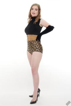 Harriet in black stretchy top, tight leather corset belt and retro-style animal-print control-briefs worn as hotpants