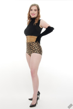 Harriet in black stretchy top, tight leather corset belt and retro-style animal-print control-briefs worn as hotpants