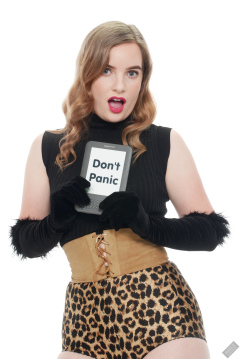 Harriet in black stretchy top, tight leather corset belt and retro-style animal-print control-briefs worn as hotpants