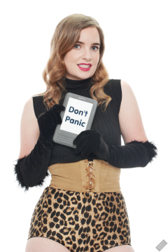 Harriet in black stretchy top, tight leather corset belt and retro-style animal-print control-briefs worn as hotpants