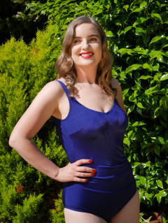 Harriet enjoys the sunshine in blue vintage one-piece swimsuit