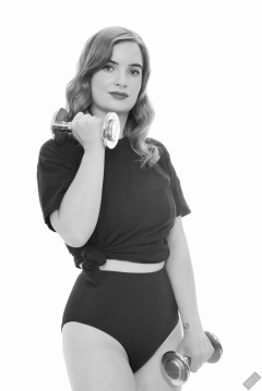 Harriet in black T-shirt, tied at the waist, with black control briefs worn as hotpants