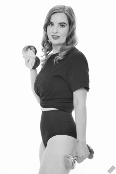 Harriet in black T-shirt, tied at the waist, with black control briefs worn as hotpants