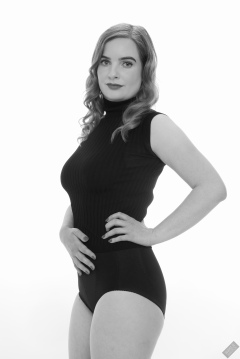 Harriet in black T-shirt, tied at the waist, with black control briefs worn as hotpants