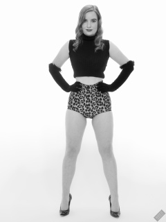 Harriet in black stretchy top and retro-style animal-print control-briefs worn as hotpants
