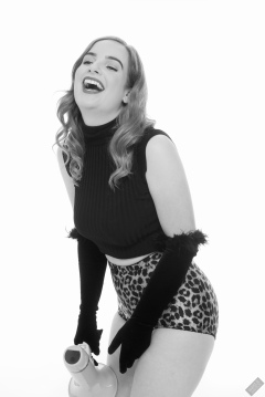 Harriet in black stretchy top and retro-style animal-print control-briefs worn as hotpants