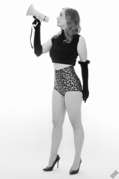 Harriet in black stretchy top and retro-style animal-print control-briefs worn as hotpants