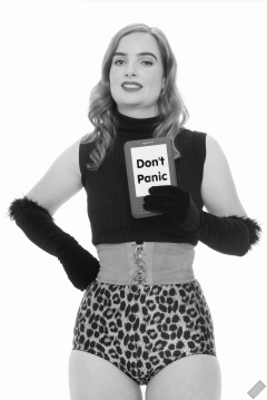 Harriet in black stretchy top, tight leather corset belt and retro-style animal-print control-briefs worn as hotpants