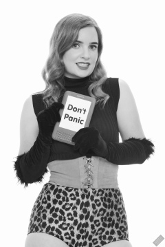 Harriet in black stretchy top, tight leather corset belt and retro-style animal-print control-briefs worn as hotpants