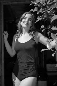 Harriet enjoys the sunshine in blue vintage one-piece swimsuit