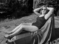 Harriet enjoys the sunshine in blue vintage one-piece swimsuit