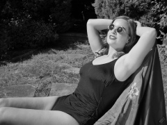 Harriet enjoys the sunshine in blue vintage one-piece swimsuit